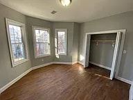 Elizabeth apartment for rent - A room with wood floors and three windows.