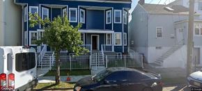 Elizabeth apartment for rent - A blue house with a white car parked in front.