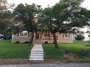 Buchanan Dam apartment for rent - the front of our house with the trees