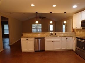 Buchanan Dam apartment for rent - a kitchen with white cabinets and a sink and a refrigerator