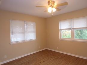 Buchanan Dam apartment for rent - A room with a ceiling fan and two windows.