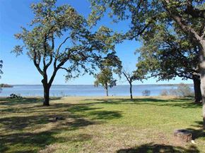 Burnet apartment for rent - A serene landscape with trees, grass, and a body of water.