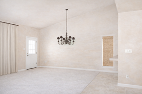 Horseshoe Bay apartment for rent - A room with a chandelier and a window with curtains.