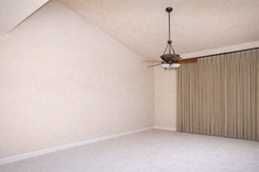 Horseshoe Bay apartment for rent - A room with a ceiling fan and a window with curtains.