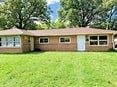 Youngstown house for rent - a brick house with a green yard in front of it