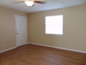 Marble Falls apartment for rent - an empty living room with a ceiling fan and a window