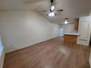 Marble Falls apartment for rent - A room with a ceiling fan and wooden flooring.