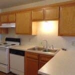 Marble Falls apartment for rent - A kitchen with wooden cabinets and a white counter top.