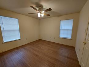 Marble Falls apartment for rent - A room with a ceiling fan and two windows.