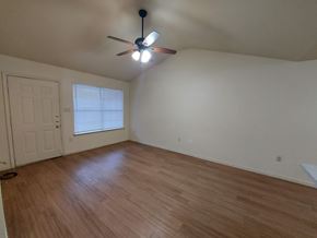 Marble Falls apartment for rent - A room with a ceiling fan and wooden flooring.