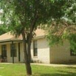 Marble Falls apartment for rent - A tree is in front of a house.