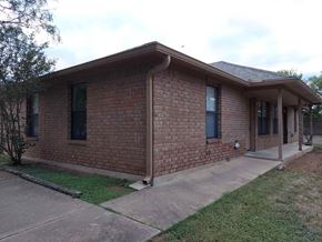 Marble Falls apartment for rent - A brick house with a porch and a covered entry way.