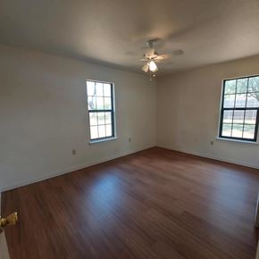 Marble Falls apartment for rent - A room with wooden floors and two windows.