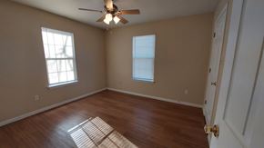 Marble Falls apartment for rent - A room with a ceiling fan and two windows.