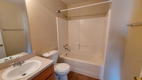 Marble Falls apartment for rent - A white bathroom with a toilet, sink, and bathtub.