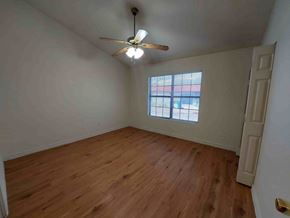 Marble Falls apartment for rent - A room with a ceiling fan and wooden flooring.