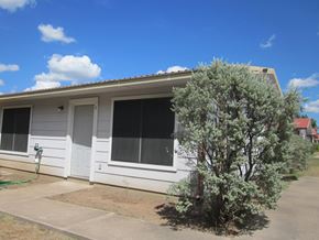 Marble Falls apartment for rent - A small white house with a tree in front.