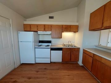Marble Falls apartment for rent - A kitchen with white appliances and wooden cabinets.