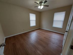 Marble Falls apartment for rent - A room with a ceiling fan and wooden flooring.