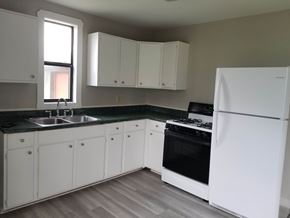 Austin apartment for rent - A kitchen with white appliances and cabinets.