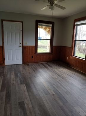 Austin apartment for rent - A room with a white door and a window with a view of trees.