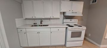 Kingsland apartment for rent - A white kitchen with a stove and oven.