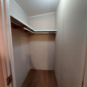 Marble Falls apartment for rent - A small, empty room with a wooden floor and a closet with shelves.