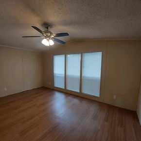 Marble Falls apartment for rent - A room with a ceiling fan and sliding glass doors.