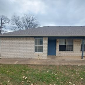 Marble Falls apartment for rent - A house with a blue door and a grey roof.