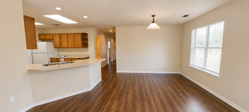 Marble Falls apartment for rent - A kitchen with wooden floors and a white countertop.