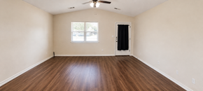 Marble Falls apartment for rent - Empty room with wood flooring and a ceiling fan.