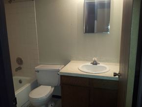 Marble Falls apartment for rent - A white toilet sits next to a white sink in a small bathroom.