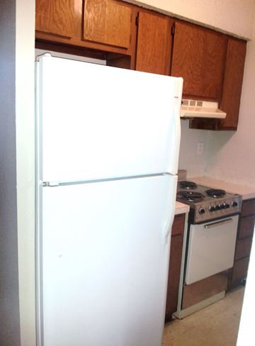 Marble Falls apartment for rent - A white refrigerator is in a kitchen next to a stove.