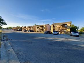 Marble Falls apartment for rent - A street view of a residential area with houses and cars.