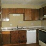 Marble Falls apartment for rent - a kitchen with wooden cabinets and a white dishwasher