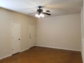 Marble Falls apartment for rent - A room with a ceiling fan and two doors.