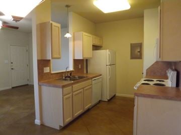 Marble Falls apartment for rent - A kitchen with a sink, stove, and refrigerator.