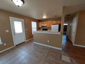 Marble Falls apartment for rent - A kitchen area with brown walls and a white door.
