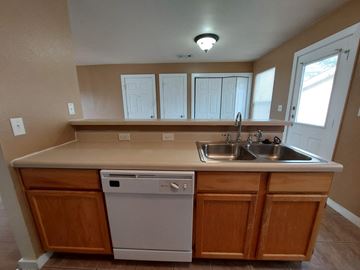 Marble Falls apartment for rent - A kitchen with a white dishwasher and a sink.