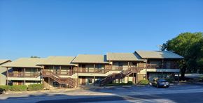 Marble Falls apartment for rent - A large building with a parking lot in front.