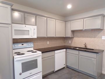 Kingsland apartment for rent - A kitchen with white appliances and cabinets.