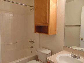 Kingsland apartment for rent - A white bathroom with a toilet, sink, and shower.