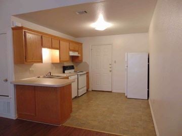Kingsland apartment for rent - A kitchen with wooden cabinets and a white dishwasher.