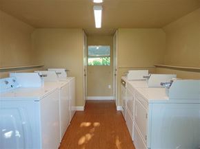 Burnet apartment for rent - an empty laundry room with white washers and dryers