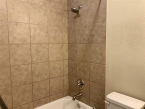 Burnet apartment for rent - a bathroom with a shower and a toilet in it