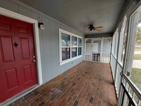 Granite Shoals apartment for rent - A red door is on the left of a porch with a ceiling fan.
