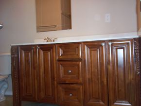 Marble Falls apartment for rent - A wooden cabinet with a white counter top and a mirror above it.