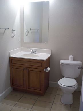 Marble Falls apartment for rent - a small bathroom with a toilet sink and mirror