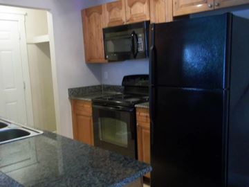 Marble Falls apartment for rent - a kitchen with black appliances and granite counter tops