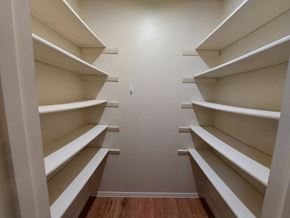 Marble Falls apartment for rent - A long hallway with white shelves on both sides.